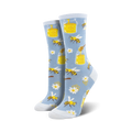 Pair of women's crew socks in light blue and orange. The socks feature a whimsical design of bees, honey jars, daisies and honeycomb.