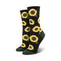 A pair of crew socks with a sunflower pattern. The socks are black with yellow sunflowers and green leaves, and have dark green cuffs.