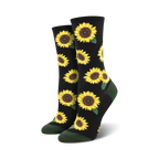 A pair of crew socks with a sunflower pattern. The socks are black with yellow sunflowers and green leaves, and have dark green cuffs.