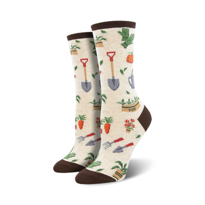 Pair of cream and green crew socks with a whimsical gardening theme.  The design includes carrots, flowers, shovels, and watering cans.