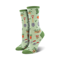 Lifestyle product shot showing the green Hoe Down socks on a model's feet.