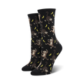 Pair of black crew socks with a playful all-over print of monkeys swinging from bananas. 