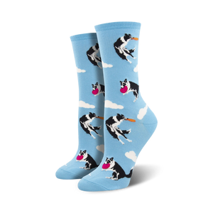 blue crew socks with black and white border collies jumping to catch pink frisbees.  