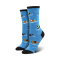 Pair of women's crew socks. Light blue background, dogs surfing in life vests, black and cream colored cuffs.