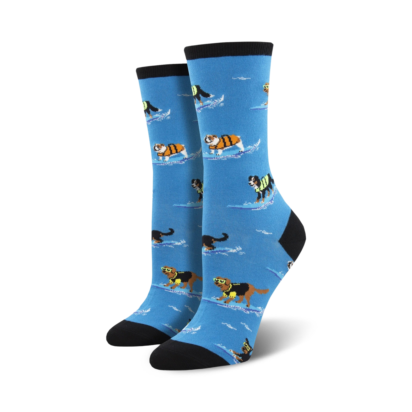 Pair of women's crew socks. Light blue background, dogs surfing in life vests, black and cream colored cuffs.
