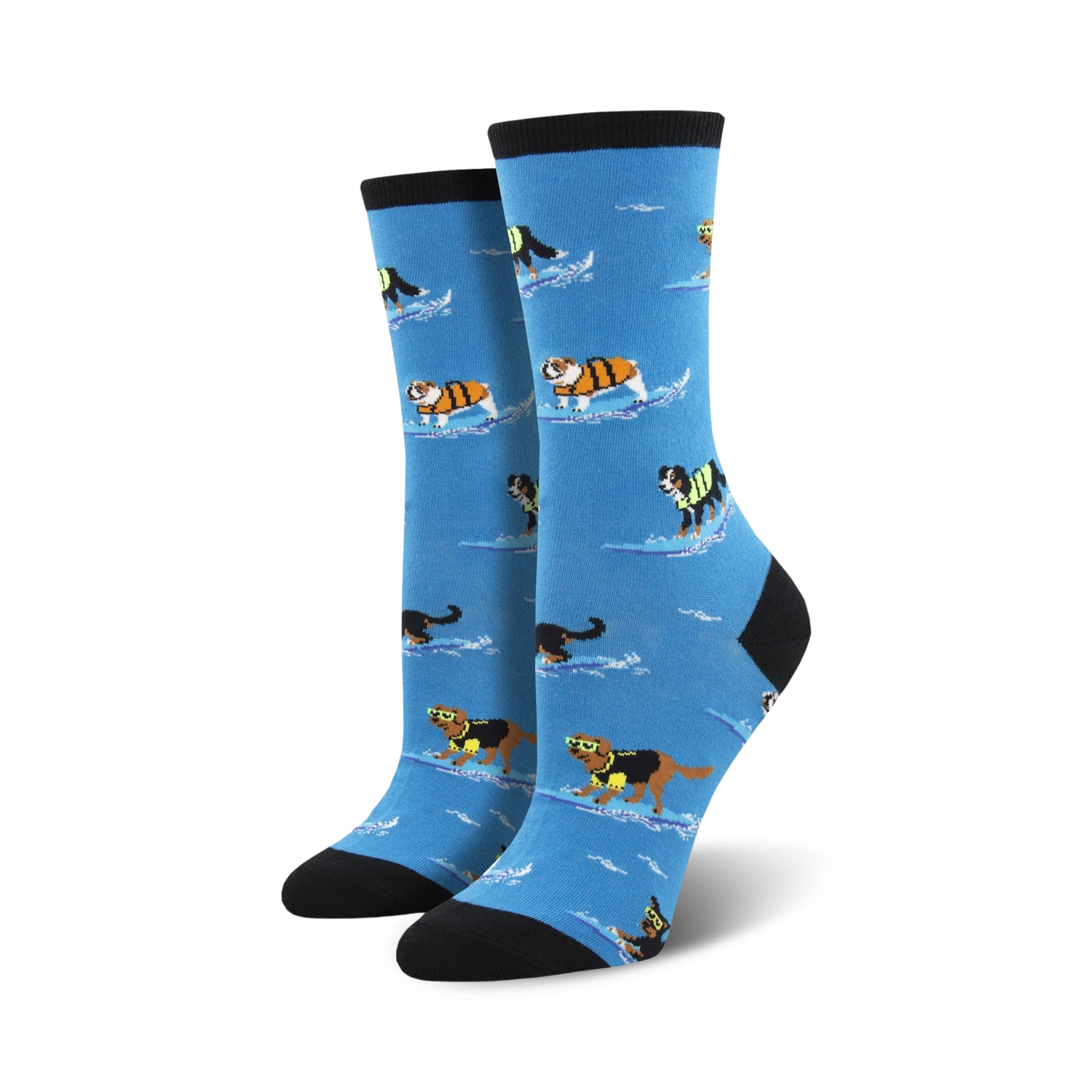 Pair of women's crew socks. Light blue background, dogs surfing in life vests, black and cream colored cuffs.