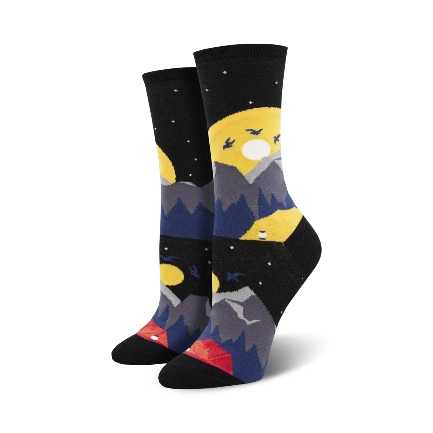 Pair of crew socks showcasing a nighttime mountain scene. The socks are primarily black with yellow moons, gray mountains, dark blue hills, and a small red tent.