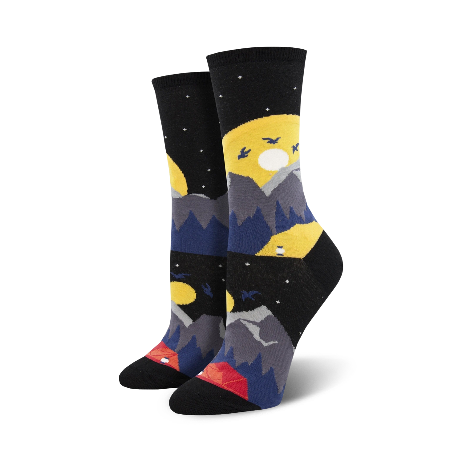 Pair of crew socks showcasing a nighttime mountain scene. The socks are primarily black with yellow moons, gray mountains, dark blue hills, and a small red tent.
