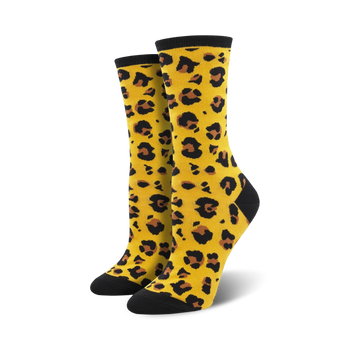womens yellow crew socks with a black toe and heel and black cuff. the main part of the sock is covered in a leopard print pattern in brown and black.  