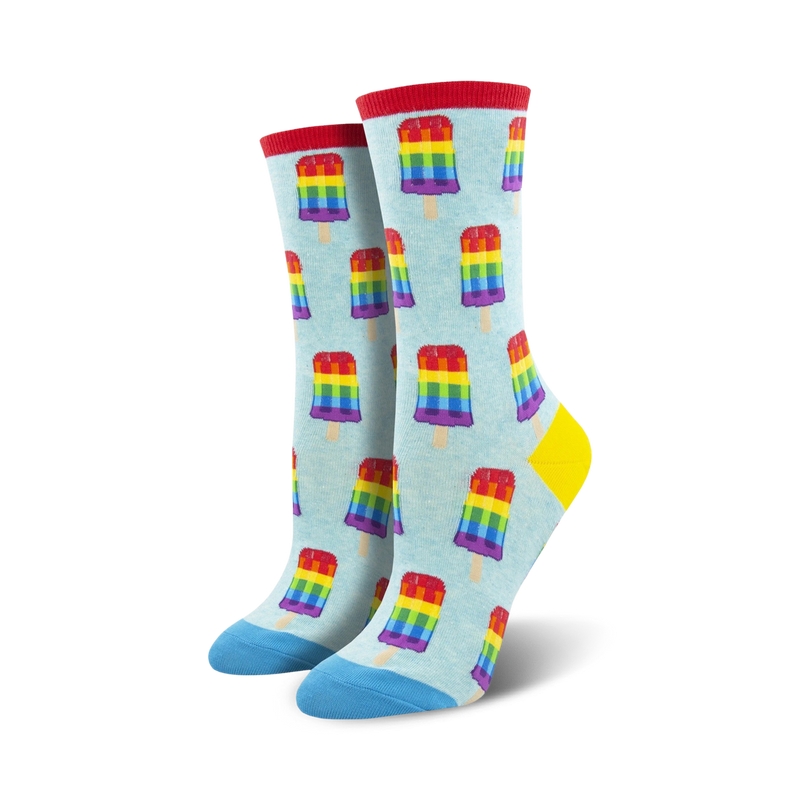 Pair of crew socks; light blue background with repeating rainbow popsicle pattern; blue and red accents at the toe and heel.