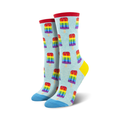 Pair of crew socks; light blue background with repeating rainbow popsicle pattern; blue and red accents at the toe and heel.