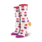 Pair of crew socks with a white background and repeating pattern of lesbian flag-colored popsicles.  Red, orange, purple, and white popsicle design; purple and orange heel and toe.