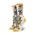Cream crew socks with a whimsical design of multicolored fish. Yellow cuffs.  Laurel Burch Pescadero.