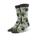 Pair of crew socks, gray with repeating green T-Rex heads. Dark gray cuff.