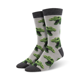 mens crew socks with green pixelated dinosaur heads on a gray background featuring solid gray toe and heel.  