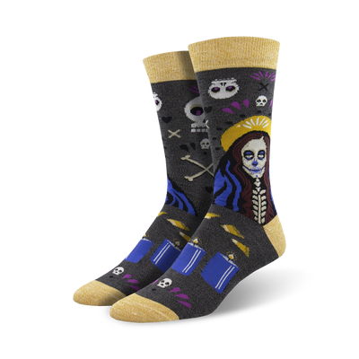 mid-calf length voodoo skull, bone, and flower design socks featuring a yellow toe and heel with the word "voodoo" on the bottom. 