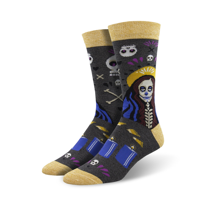 mid-calf length voodoo skull, bone, and flower design socks featuring a yellow toe and heel with the word 