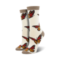 Pair of cream women's crew socks adorned with orange and brown monarch butterfly prints.  Features a subtle taupe cuff.