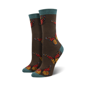 brown bamboo women's crew-length socks featuring an allover pattern of dark orange, black, and yellow monarch butterflies; teal blue toes and heels.  