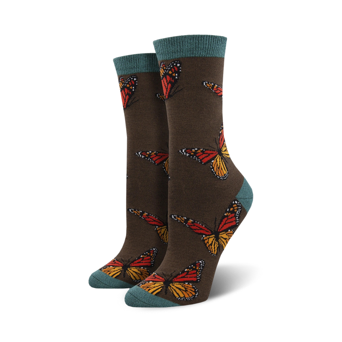 brown bamboo women's crew-length socks featuring an allover pattern of dark orange, black, and yellow monarch butterflies; teal blue toes and heels.  