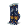 Pair of women's crew socks with a navy blue background. Features suns, moons, shooting stars, and light blue cuffs.