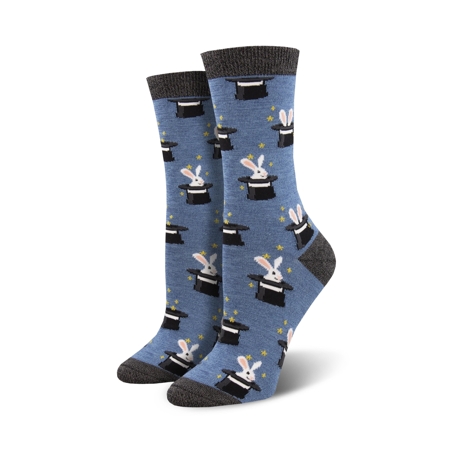 A pair of women's crew socks in blue with a pattern of white rabbits popping out of black top hats.