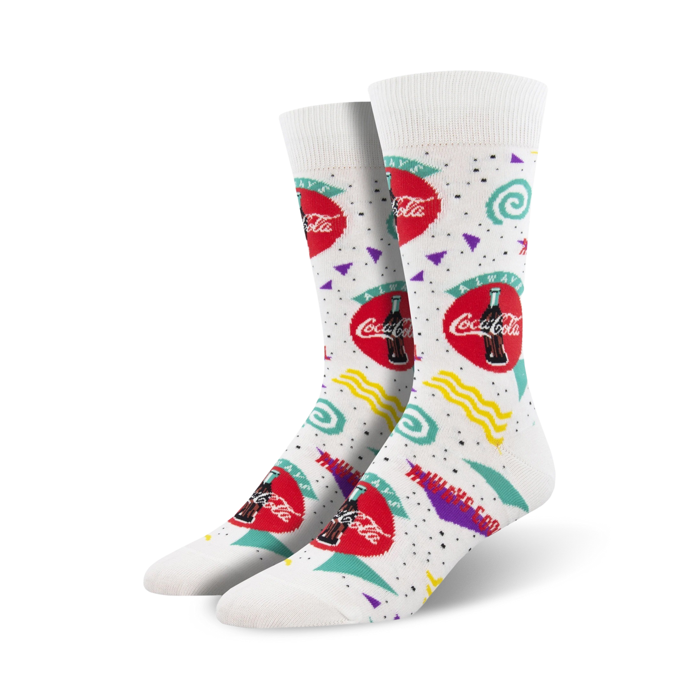 A pair of white crew socks with a 90s-themed Coca-Cola design. The socks feature red Coca-Cola logos, and teal, purple, and yellow geometric shapes.