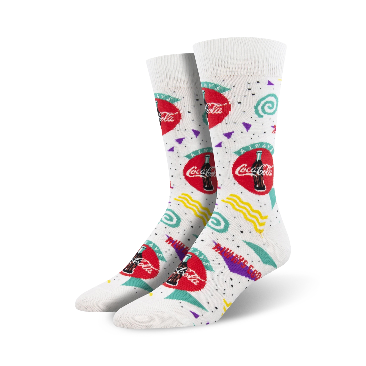A pair of white crew socks with a 90s-themed Coca-Cola design. The socks feature red Coca-Cola logos, and teal, purple, and yellow geometric shapes.