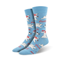 A pair of crew socks in light blue featuring a repeating pattern of polar bears, penguins, and Coca-Cola logos.