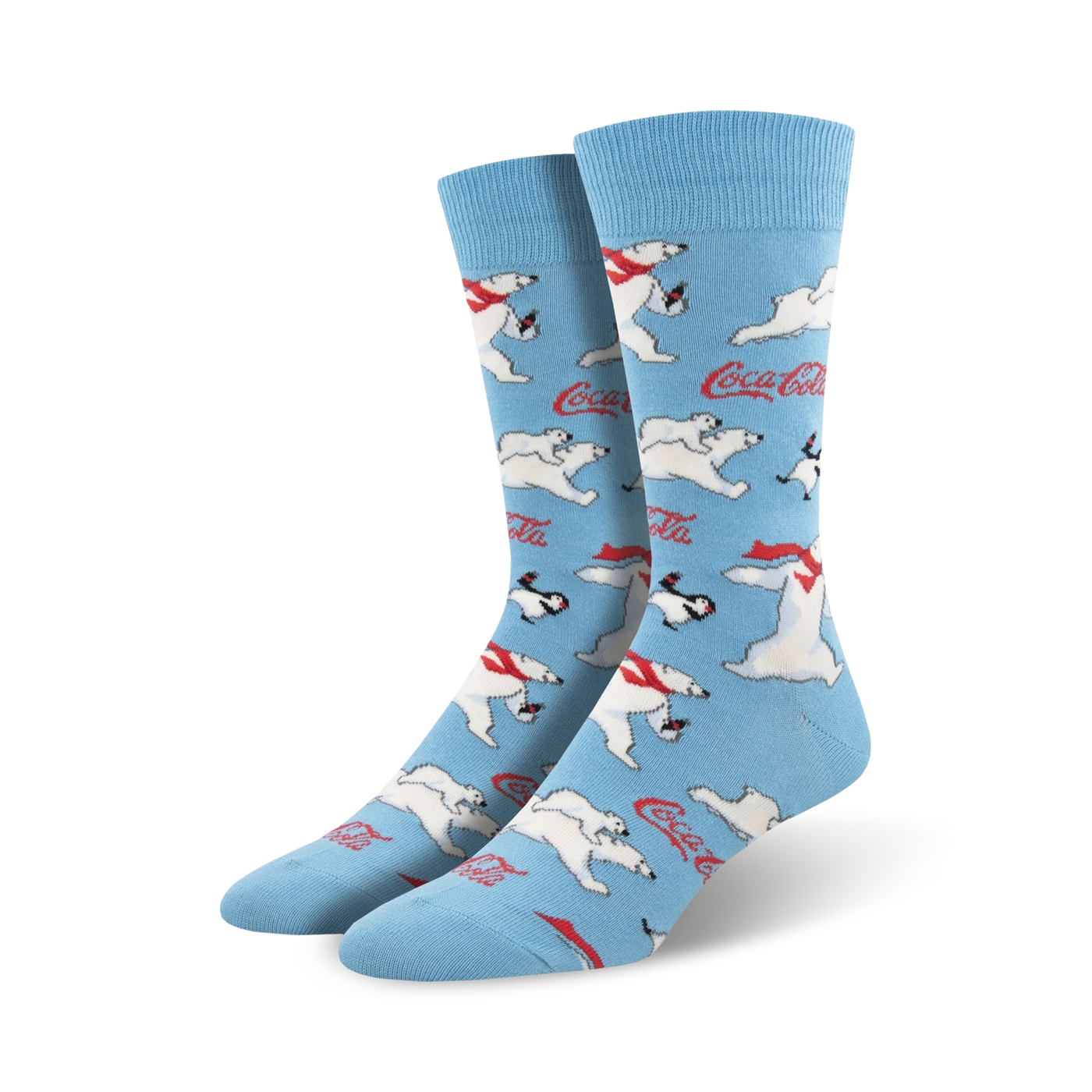 A pair of crew socks in light blue featuring a repeating pattern of polar bears, penguins, and Coca-Cola logos.