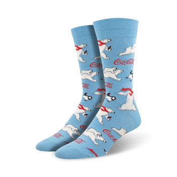 A pair of crew socks in light blue featuring a repeating pattern of polar bears, penguins, and Coca-Cola logos.