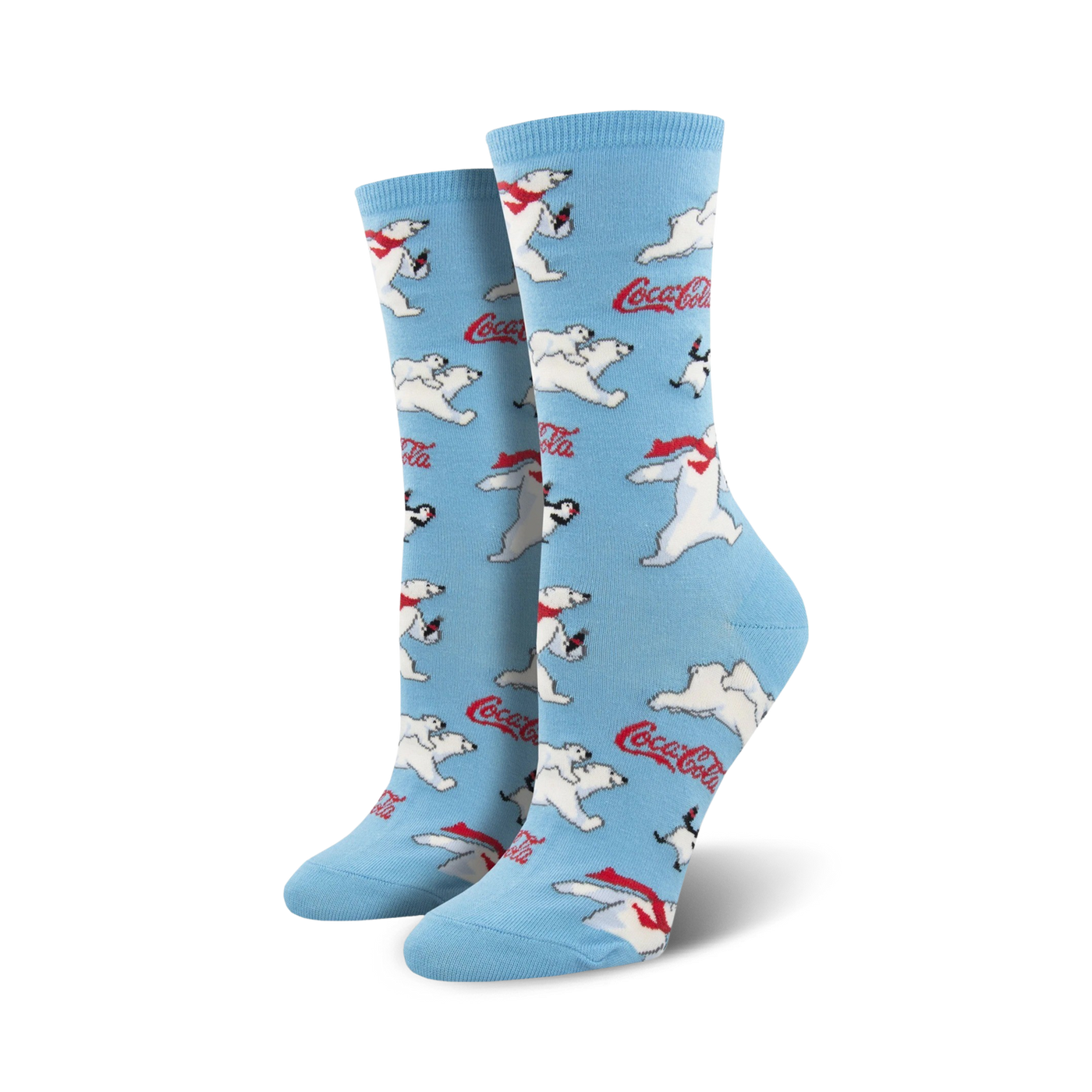 A pair of women's crew socks in light blue. The socks are covered in a pattern of polar bears wearing red scarves, penguins, and Coca-Cola logos.