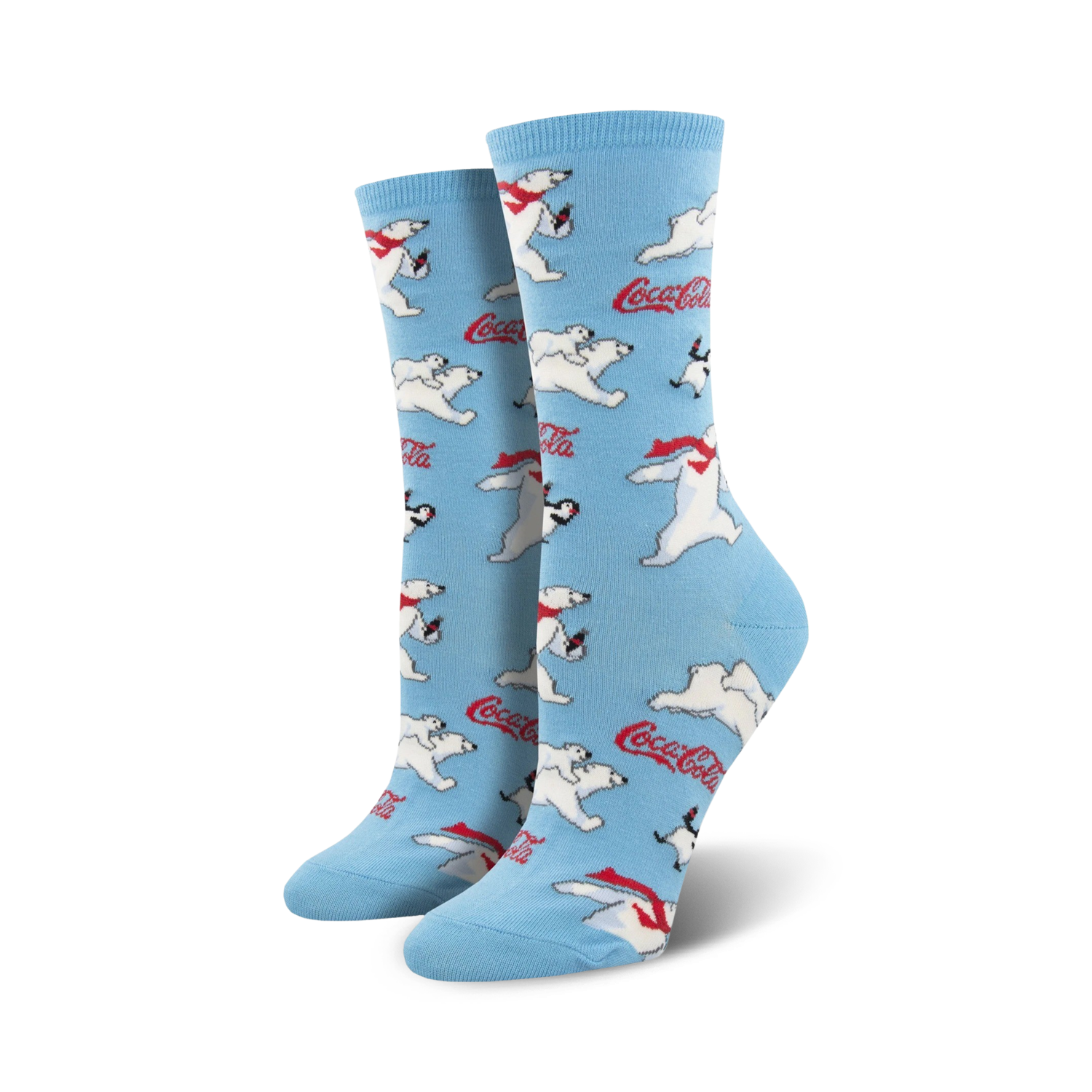 A pair of women's crew socks in light blue. The socks are covered in a pattern of polar bears wearing red scarves, penguins, and Coca-Cola logos.