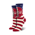 Pair of crew socks with red and white stripes, a Coca-Cola logo, and an American flag motif.