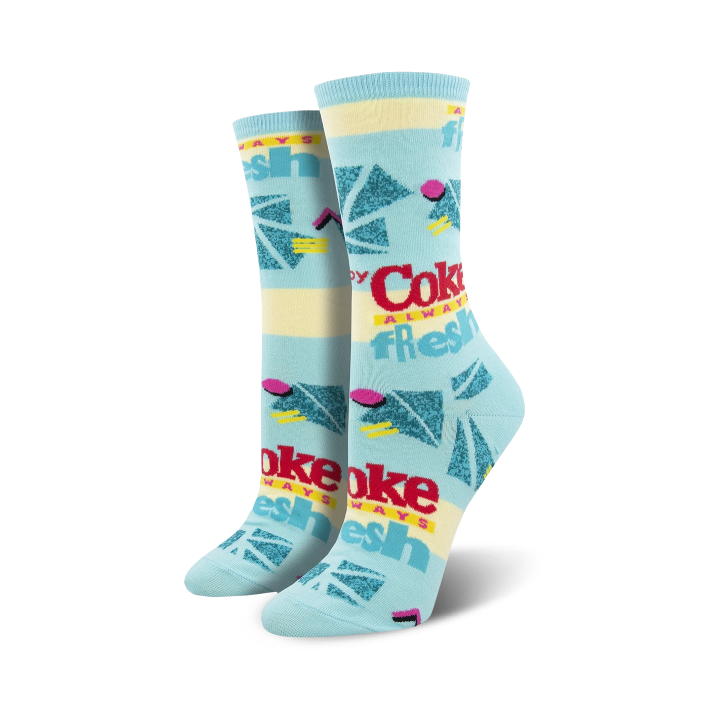 Pair of women's crew socks in pastel blue and yellow, featuring a retro Coca-Cola design with geometric shapes and the text 'Always Fresh'.