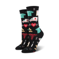 Pair of black crew socks with colorful medical icons: red caduceus symbol, teal scrubs, ambulances, EKG lines, bandages, and syringes.