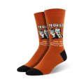 A pair of orange crew socks with a retro-style graphic of a man holding tequila shots and the text, 'Have you hugged your toilet today?'