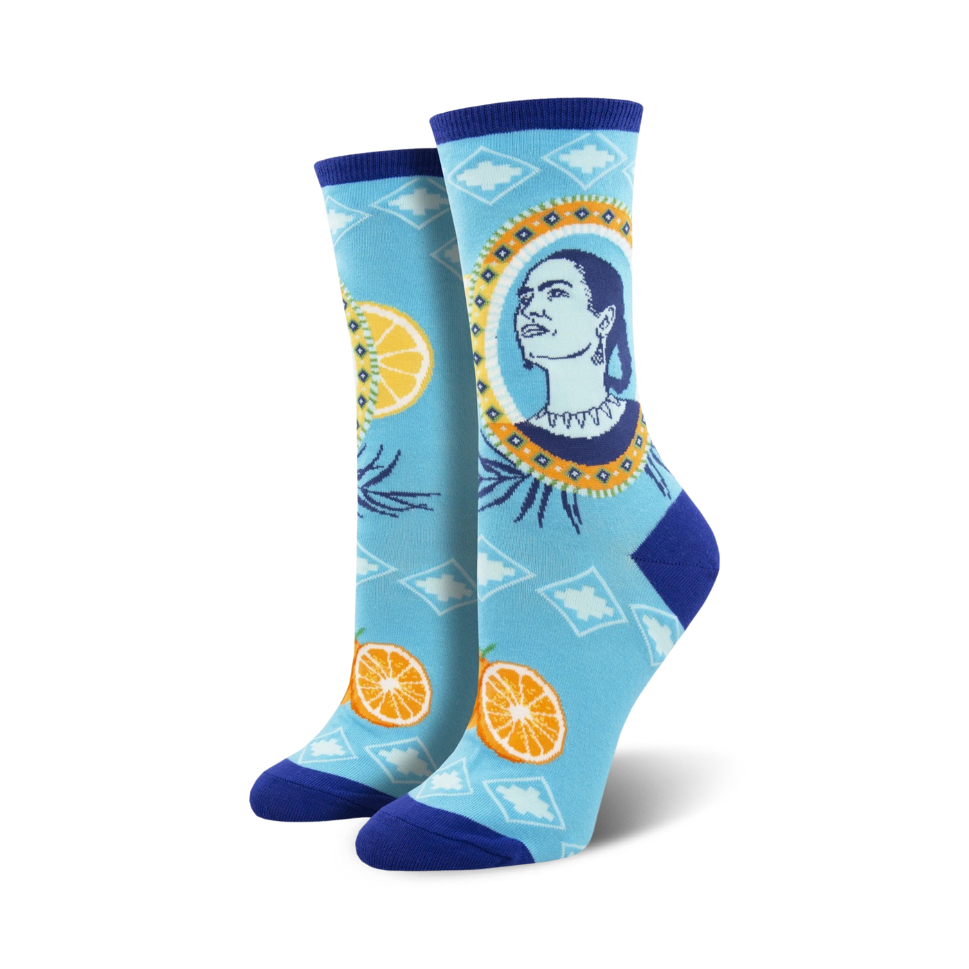 Pair of Frida Kahlo-themed crew socks. Light blue background with oranges, artistic portrait of Frida, and geometric patterns.