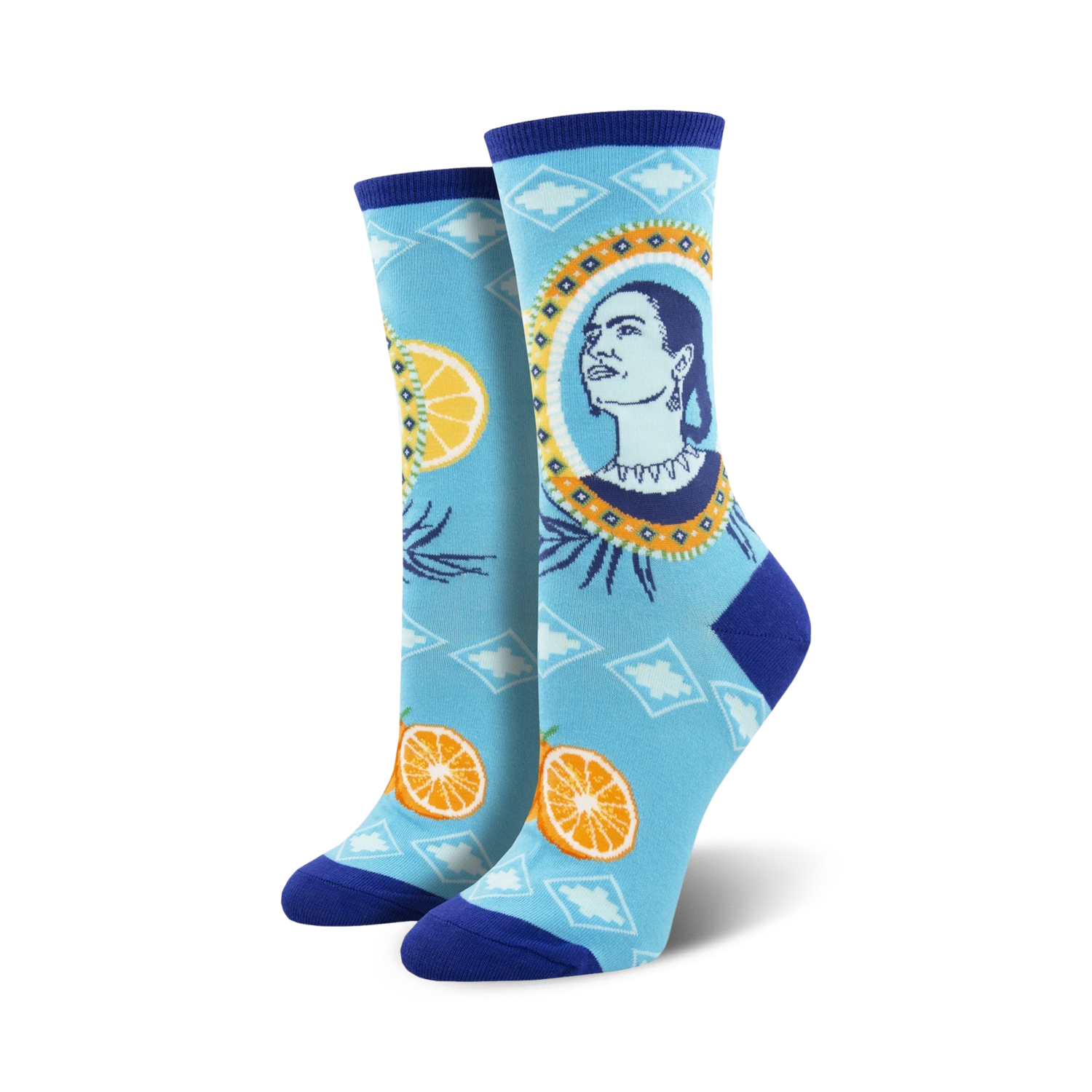 Pair of Frida Kahlo-themed crew socks. Light blue background with oranges, artistic portrait of Frida, and geometric patterns.