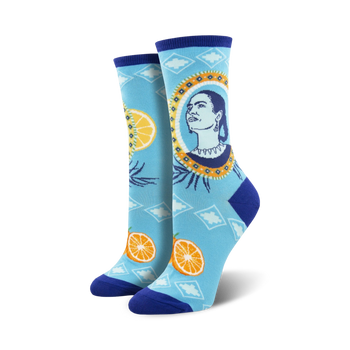 blue crew socks feature frida kahlo, an orange, and a lemon.   