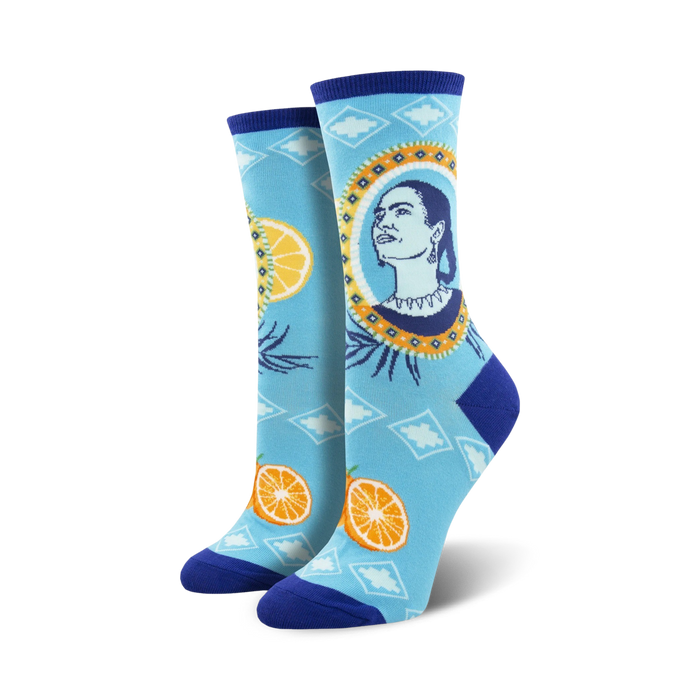 blue crew socks feature frida kahlo, an orange, and a lemon.   