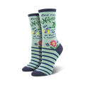 Pair of women's crew socks in light teal with navy stripes. Features a Maya Angelou quote and colorful floral accents.