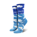 Pair of crew socks in shades of blue, featuring a sky and clouds design with Maya Angelou's 'Still I Rise' quote.