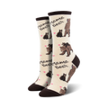 Lifestyle shot of a pair of Mama Bear socks on a person's feet.  Socks shown are in cream and brown.