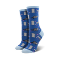 Lifestyle photo: Person wearing blue 'Trashy Love' socks with black combat boots and sitting on a skateboard.
