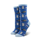 Lifestyle photo: Person wearing blue 'Trashy Love' socks with black combat boots and sitting on a skateboard.