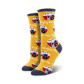 Pair of crew socks in yellow and navy blue featuring a repeating pattern of vintage camper vans and the phrase 'Enjoy the Ride'.