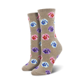 Lifestyle shot showing Blooming Pansy socks in taupe on a model's feet.  The socks have pink, purple, and light blue pansies.