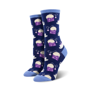 dark blue crew socks for women featuring a delightful pattern of light blue teapots with stars and moons with little purple tea bags coming out of the spouts.  