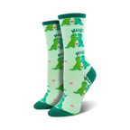 Pair of women's crew socks, light green with teal dinosaurs hugging, and pink hearts. Text says 'HUG!'